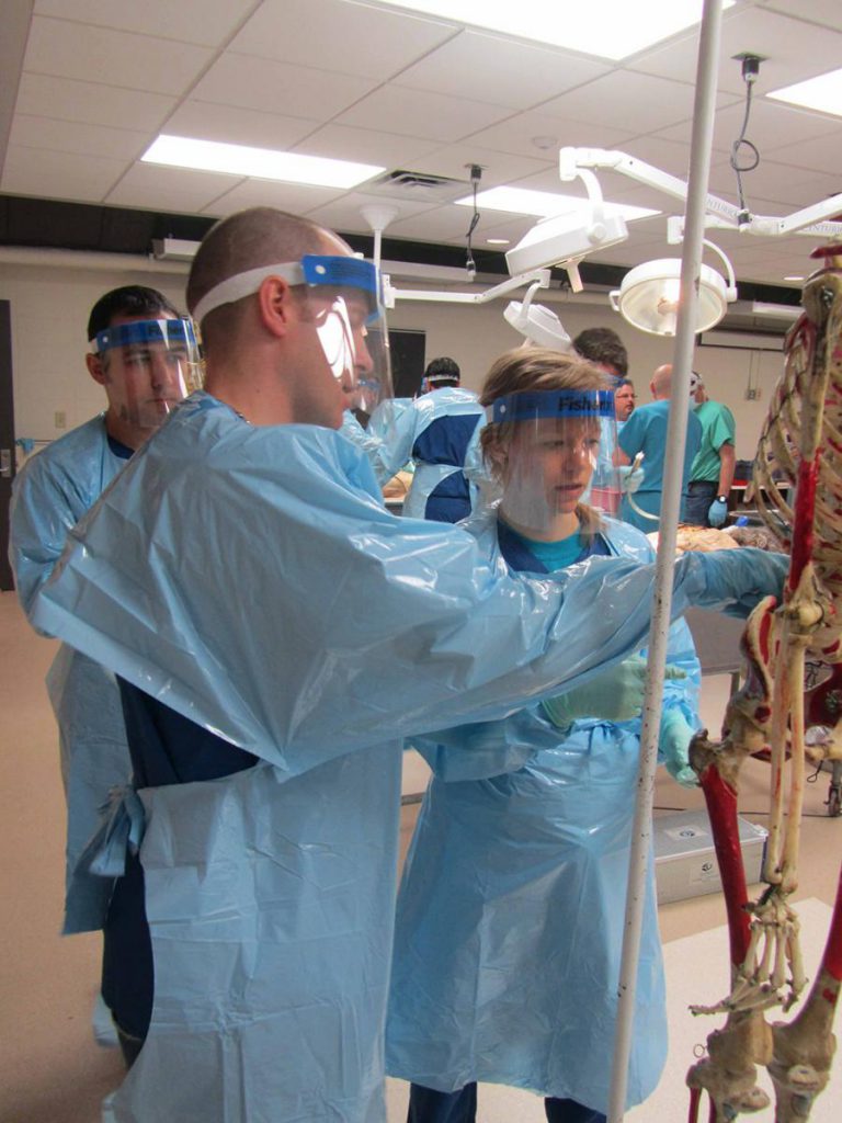 Resident Kimberly Hamilton, M.D., Faculty, Nathaniel Brooks, M.D., and Research Associate, Ulas Cikla, M.D. attending the Spine Surgery Lab