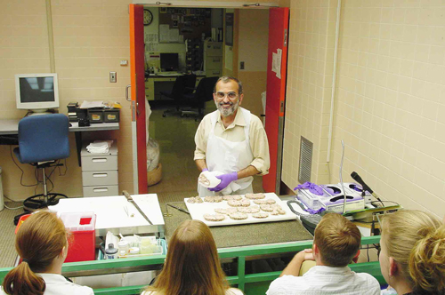 Neuropathologist and expert teacher, Dr. Shahriar Salamat, at brain cutting.