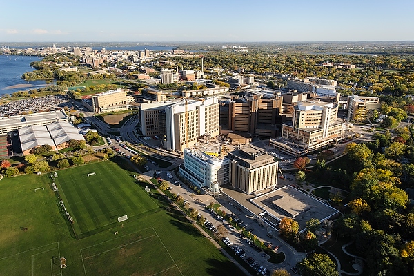 Aerial view of the Health Sciences Campus. In this photograph, the VA Hospital (right) connects to the UW Hospital (middle), American Family Children's Hospital (bottom right), UW Medical Foundation Centennial Building (MFCB, Right), Wisconsin Institutes Medical Research (WIMR, Left), Health Sciences Learning Center (HSLC, middle top) and Rennebohm Hall (Pharmacy Building, top left). Also included in picture, is the Waisman Center (bottom).