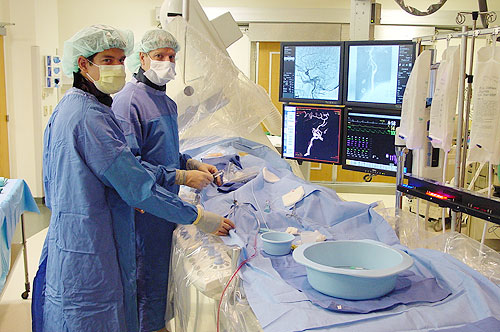 Dr. David Niemann (faculty neurosurgeon, who is also fellowship trained in endovascular), and former resident neurosurgeon Dr. Brandon Rocque (far left) at work in our interventional neuroradiology suite. We provide a full spectrum of endovascular procedures for treating aneurysm, AVM, and occlusive disease.