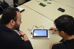 Lab members presenting an ECG simulator with pacemaker integration for real-time training of the diagnosis and treatment of arrhythmias.