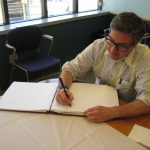 Dr. Rabkin signing the visitor book